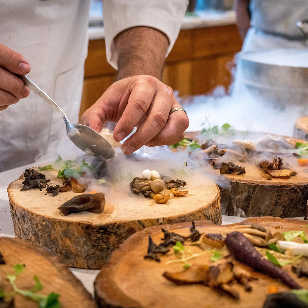 Chef serving food on decorative board
