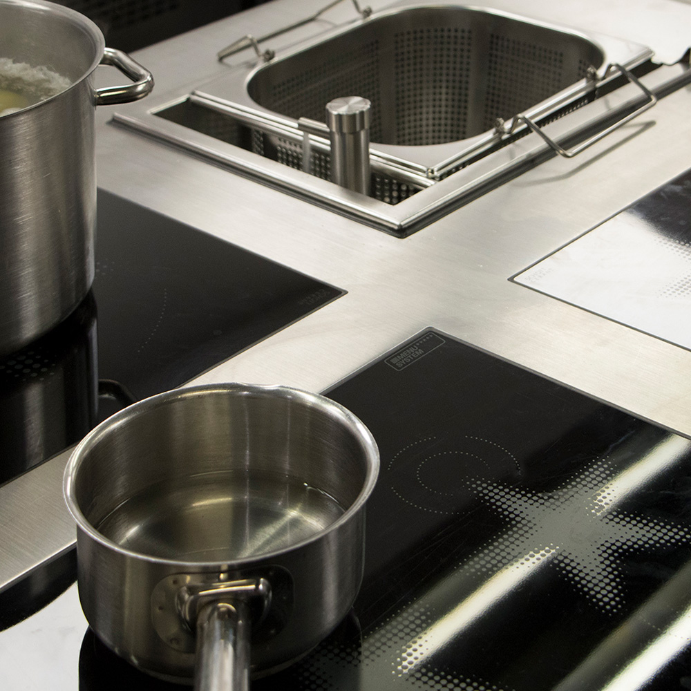 Close up of pans on Menu Systems induction hob